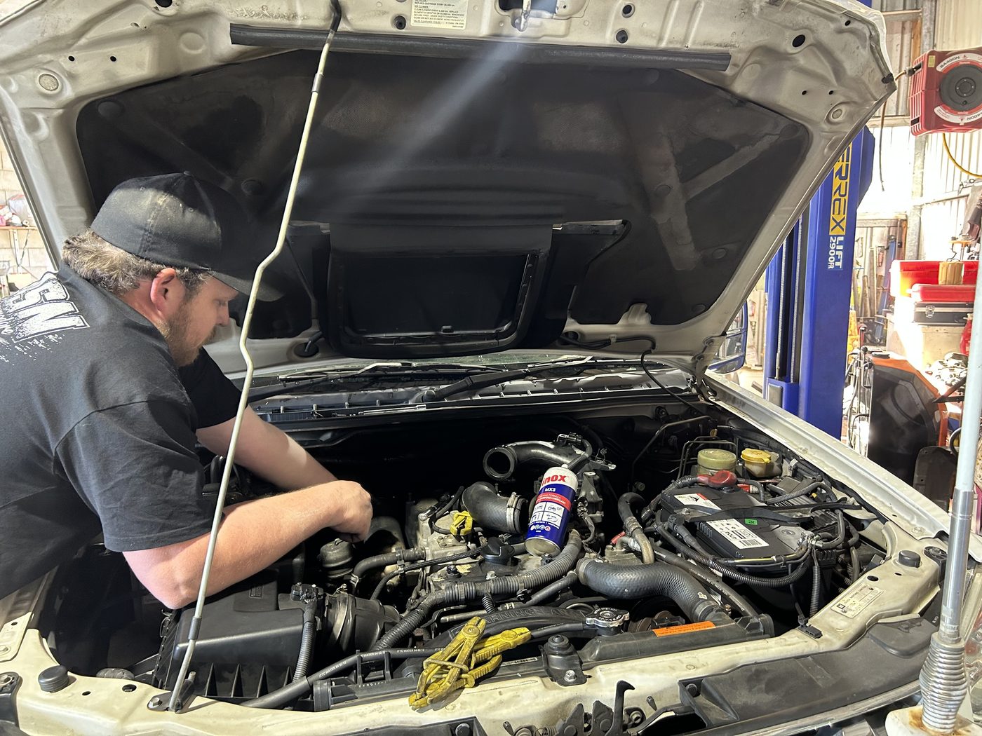 B&A technician working in a vehicle engine bay